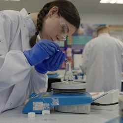 A competitor looks at some lab equipment during the final