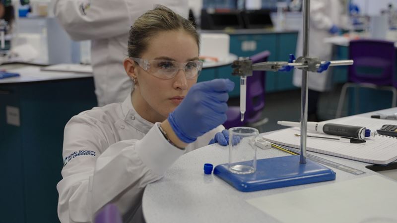 Anastasiya Kovtun carries out an experiment with some lab equipment