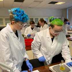 Two students look at some equipment as they take part in an experiment