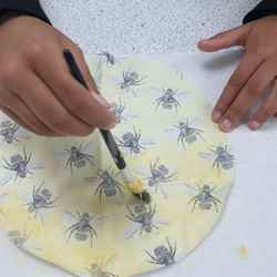 A student makes a beeswax food wrapper.
