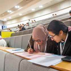 Students work away at a problem in a lecture hall at the University of East London