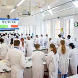 Students stand in a lab as part of the Top of the Bench final activities