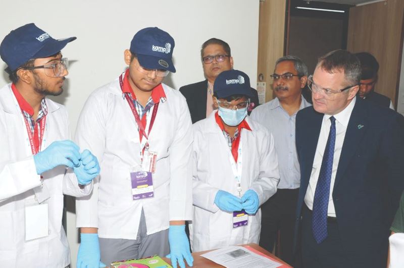 Dr Paul Lewis (right) speaks with researchers in India
