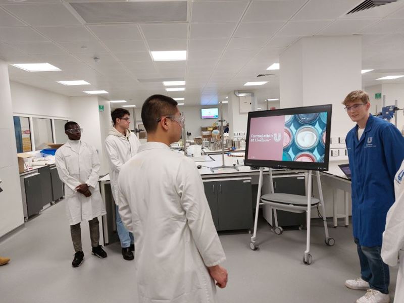 Students look at a Unilever lab during a Broadening Horizons site visit