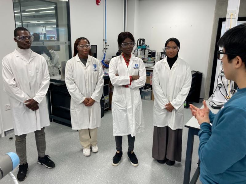 Broadening Horizons participants look around a lab during a site visit