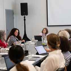 Sara Bosshart (centre) sits around a table listening to a speaker to the left of the picture during a conversation at an ACS event in San Francisco, USA