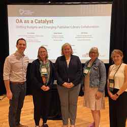 Five members of the RSC team stand in front of a screen that reads "OA as a catalyst" at an event in Charleston, South Carolina, USA