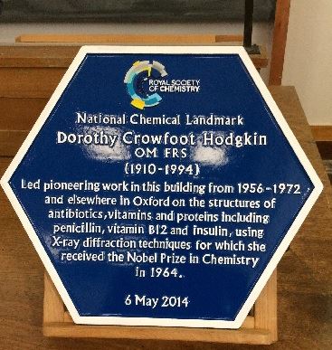 A blue National Chemical Landmark plaque in honour of Dorothy Crowfoot Hodgkin