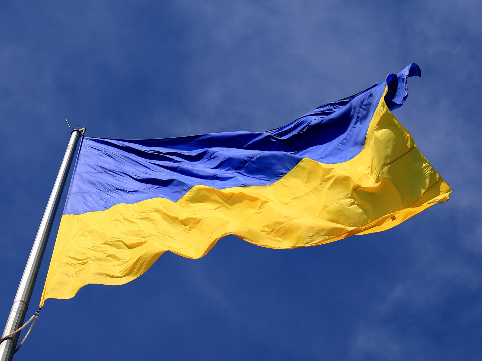 Ukraine flag with blue sky in background