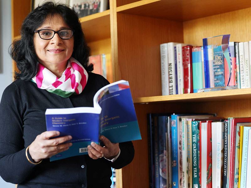 Professory Anju Massey-Brooker is pictured holding a book