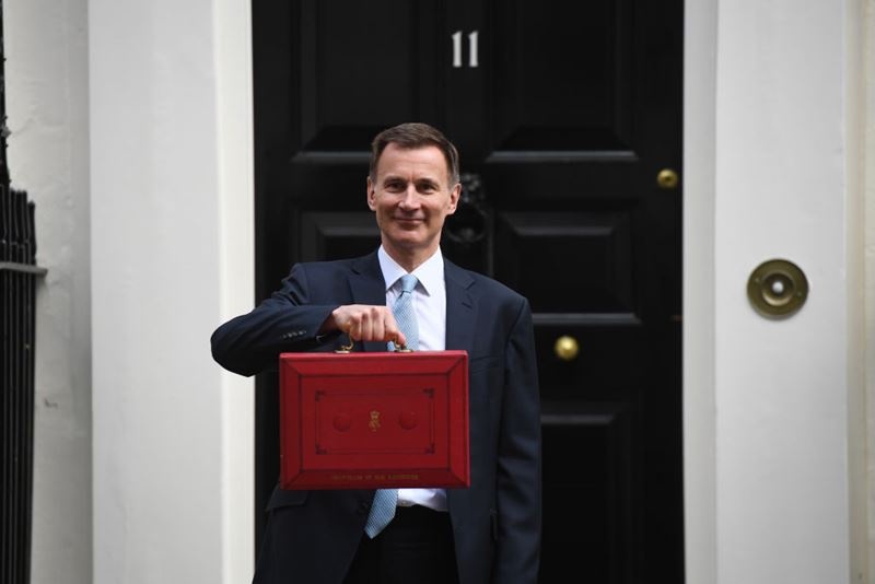 Chancellor of the Exchequer Jeremy Hunt holds aloft the red budget box outside 11 Downing Street