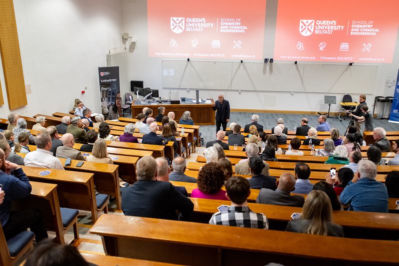 Hundreds of people watch Prof AP de Silva give a speech in a lecture hall at Queen's University Belfast after the unveiling