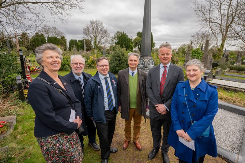 Gill Reid, Michael Harriott, Kevin Morgan, Johnny Andrews, Robert Andrews and Helen Pain stand beside the restored grave of Thomas Andrews