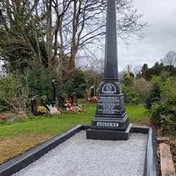 The column at the grave looks much newer even though it is the same one and the base is covered with white stones