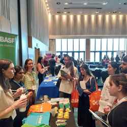 Several programme participants visit the stall of BASF