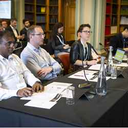 The judging panel looks on during one of the presentations at Burlington House
