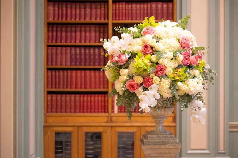 Flowers in front of bookcase