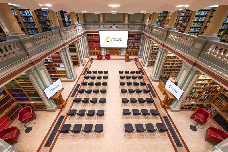 aerial view of library with rows of chairs facing large screen