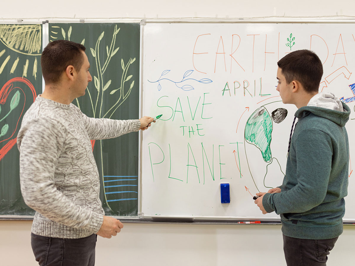 Student and teacher at white board